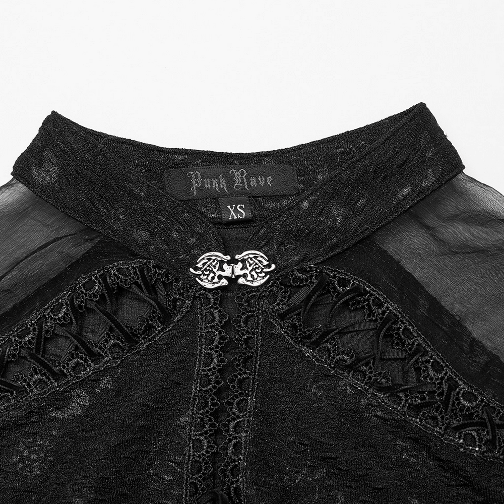 Close-up of a Gothic dress neckline with intricate lace details and a decorative clasp.