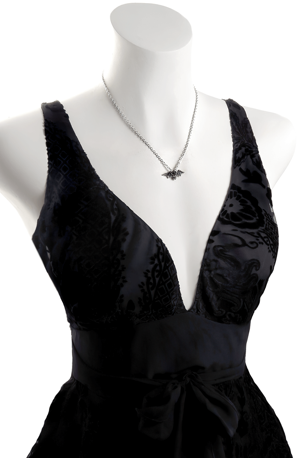 Gothic flying bat pendant necklace showcased on a black evening dress, exuding dark elegance.