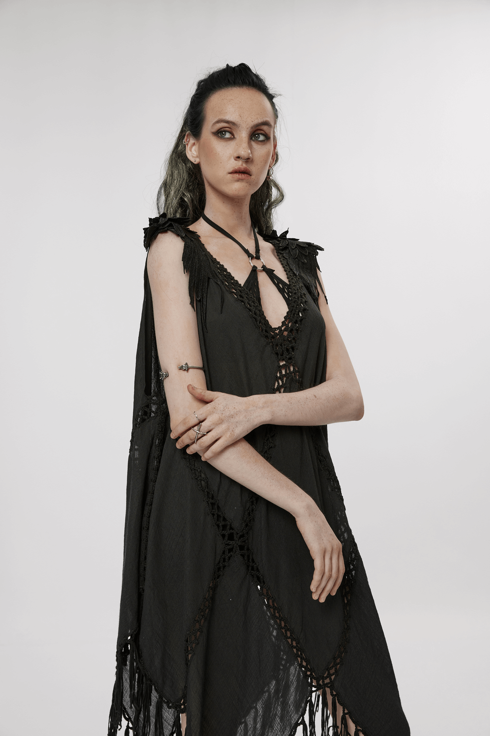 Gothic Fringe V-Neck Dress with Boho Mesh Overlay on model, showcasing unique hollow patterns and tasseled hem.