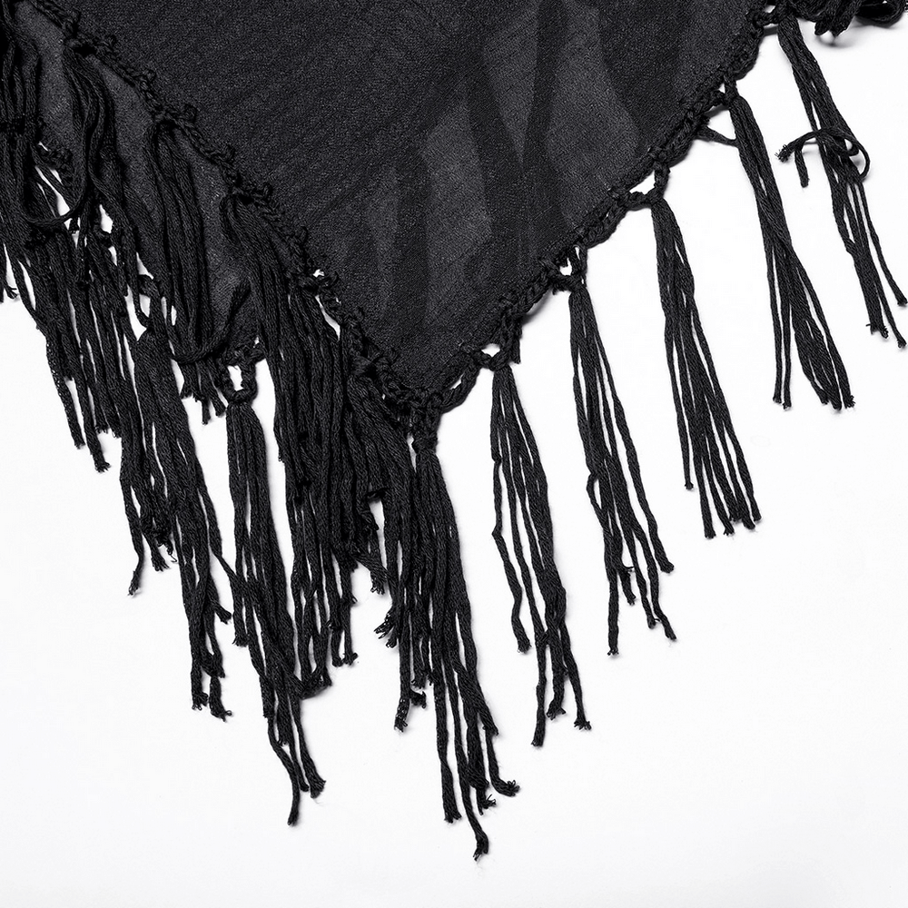 Black fringed shawl with flowing tassels, perfect for adding a touch of boho chic style to any outfit.