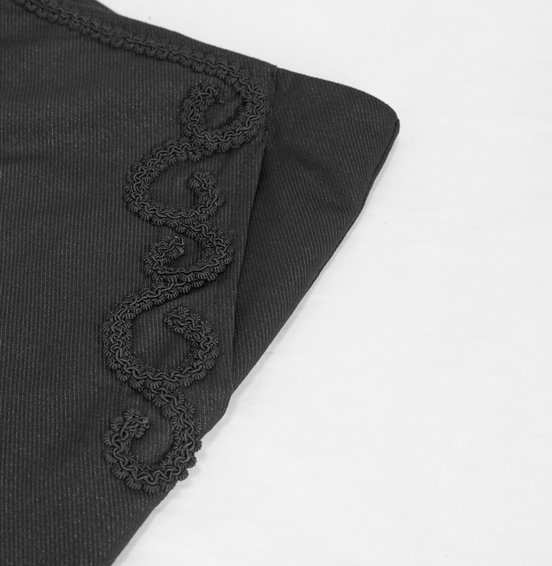 Detailed close-up of gothic black pants showcasing intricate lace pattern decoration.