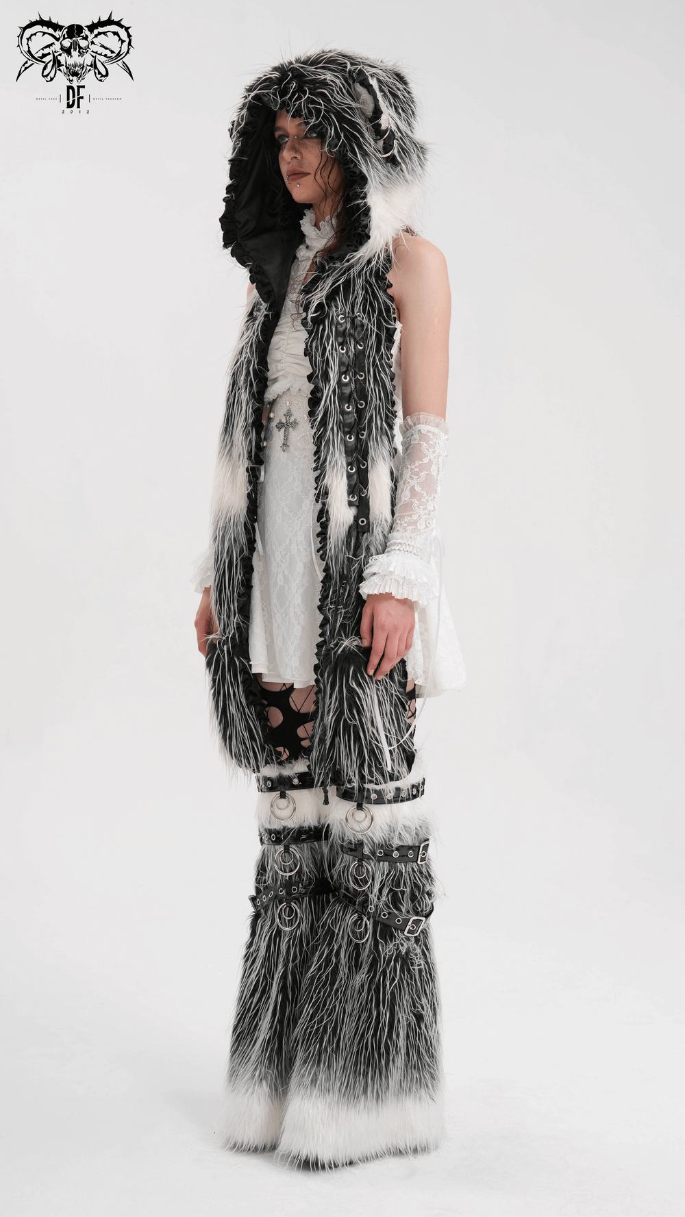 Gothic fur leg warmers with O-rings and straps, featuring black and white faux fur, worn by a model in alternative fashion attire.