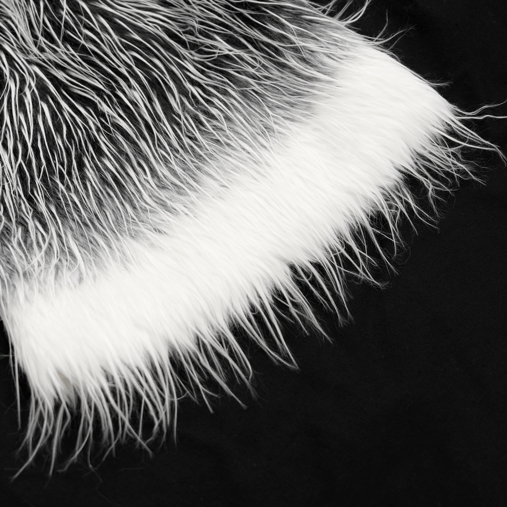 Close-up of black and white faux fur detail on Gothic leg warmers, highlighting luxurious texture and dramatic style.