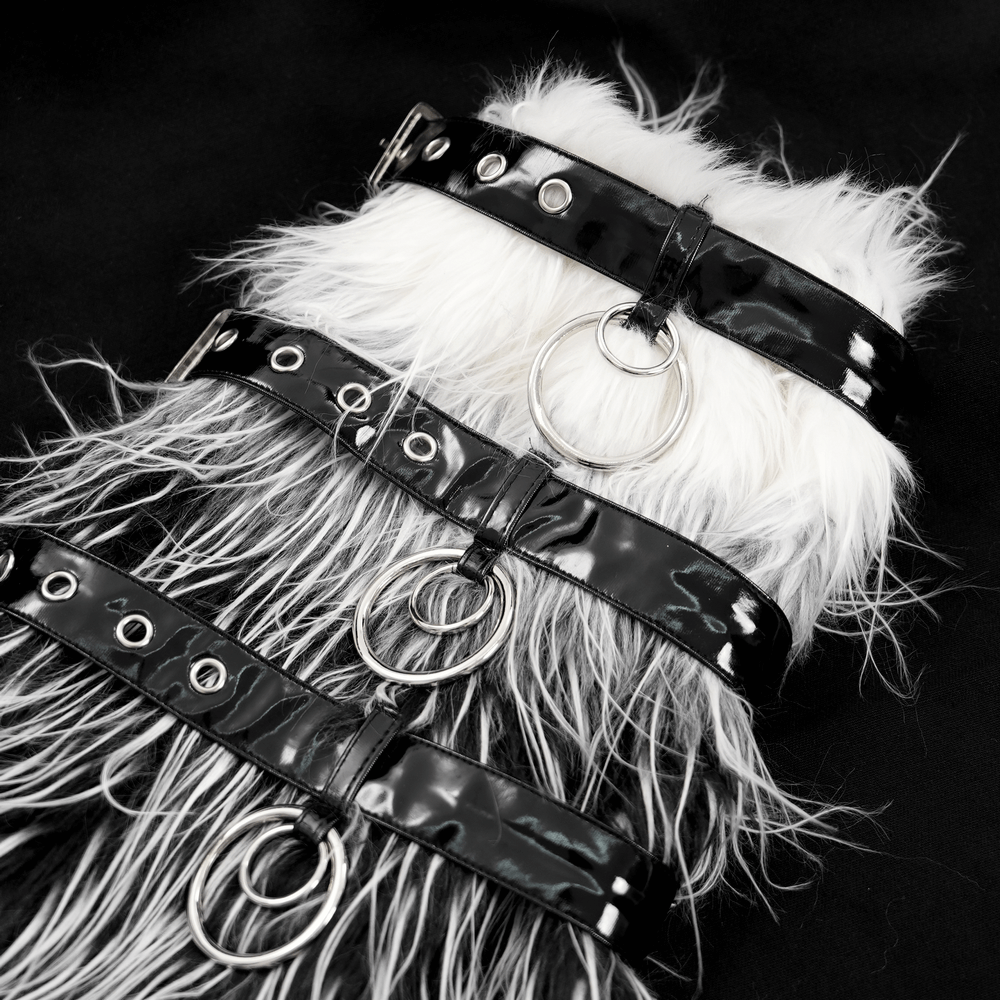 Gothic fur leg warmers with black straps and O-rings, featuring striking black and white faux fur for a punk fashion statement.