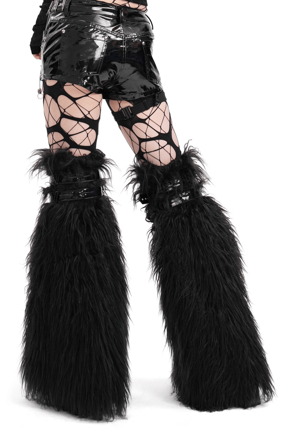 Gothic furry leg warmers with cross straps, studs, and faux fur, styled with edgy fishnet and patent skirt for punk fashion.