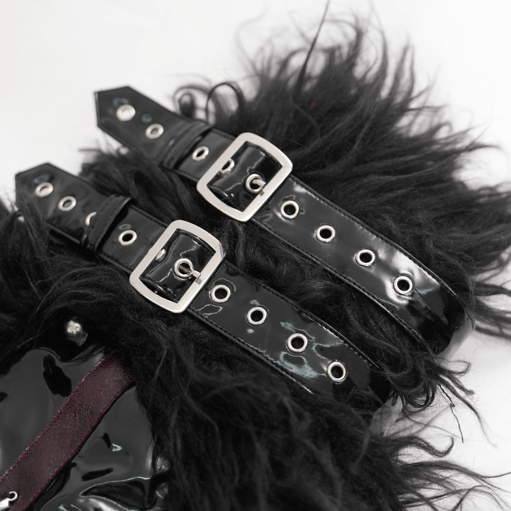 Close-up of Gothic furry leg warmers featuring black faux fur, shiny buckle straps, and studs.