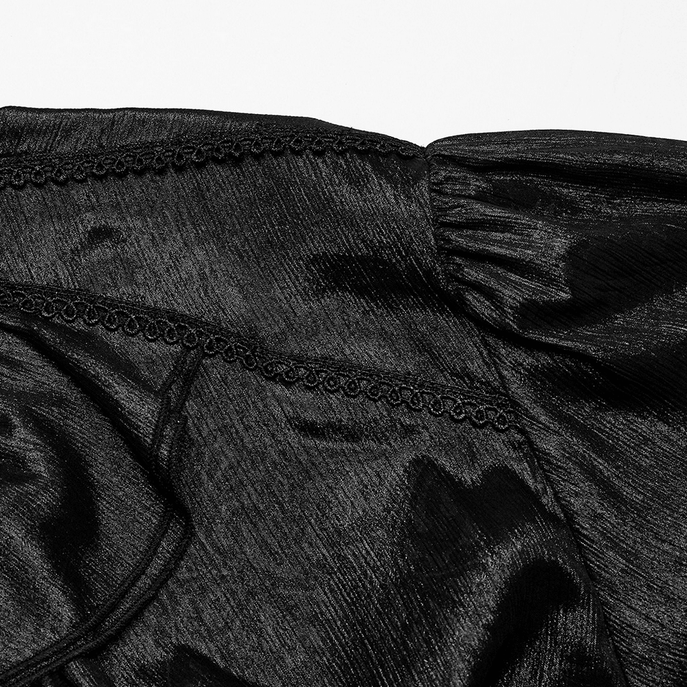 Close-up of dark sparkling pleated chiffon fabric with elegant lace details for a Gothic gentleman shirt.