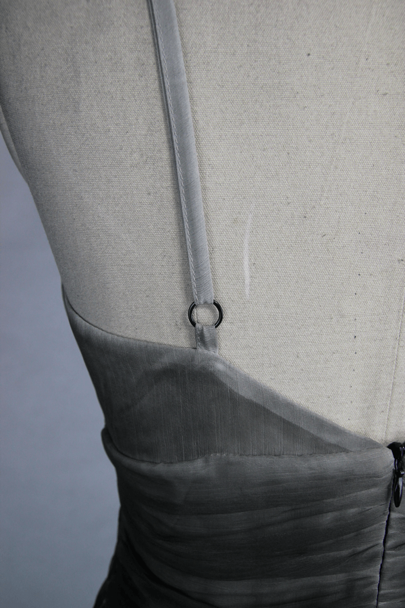 Close-up of the stylish back and strap detail of a gothic gray deep V backless dress for women.