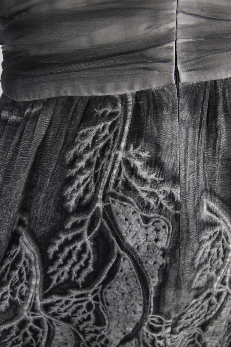 Close-up of the gothic gray backless dress showcasing intricate vintage patterns and allure of the fabric.