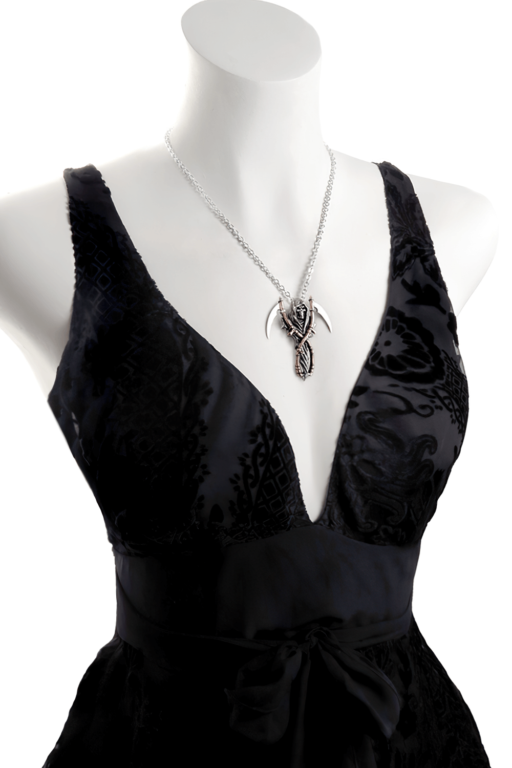 Elegant gothic Grim Reaper pendant with dual scythes showcased on a black dress mannequin.