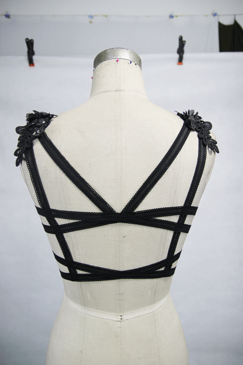 Back view of women's gothic black top with floral details and crisscross straps for a stylish look.