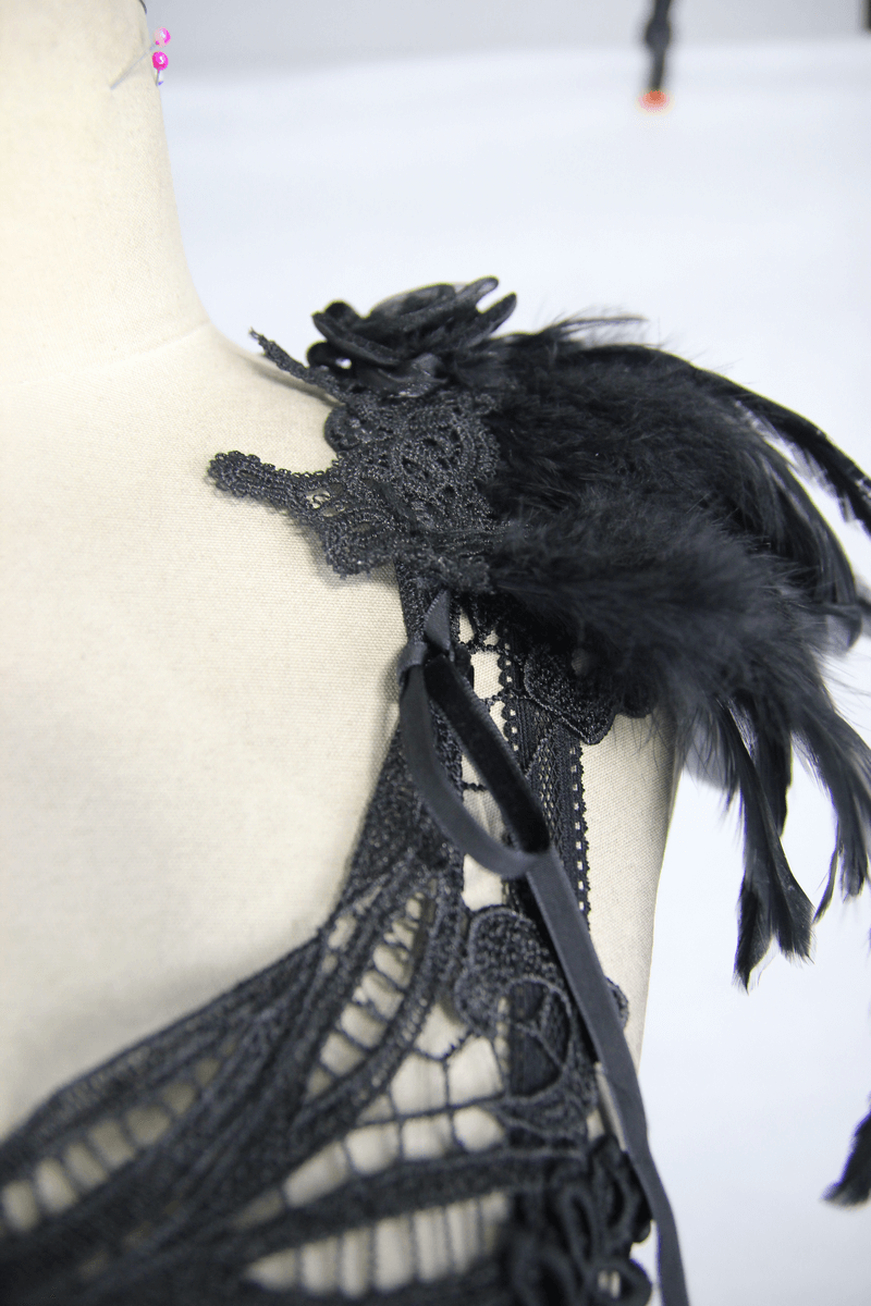 Close-up of black guipure top with feather accents, showcasing gothic style and intricate lace details.