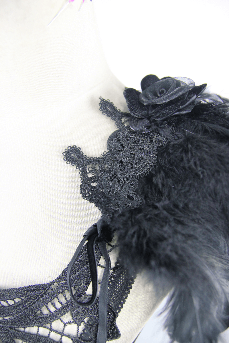 Close-up of gothic black guipure top featuring lace detail and detachable feather accents for a stylish look.