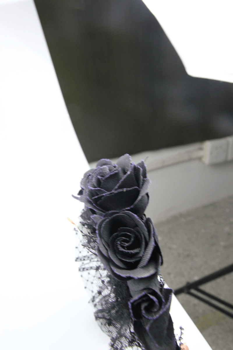 Elegant black floral hair wreath featuring rose-shaped accents, perfect for gothic-inspired hairstyles.