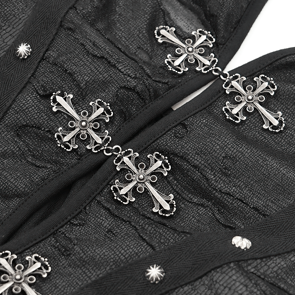 Close-up of gothic halter dress featuring intricate cross embellishments and textured fabric details.