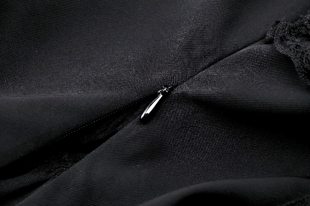 Close-up of black fabric showcasing the intricate zipper detail of a Gothic halter corset top.