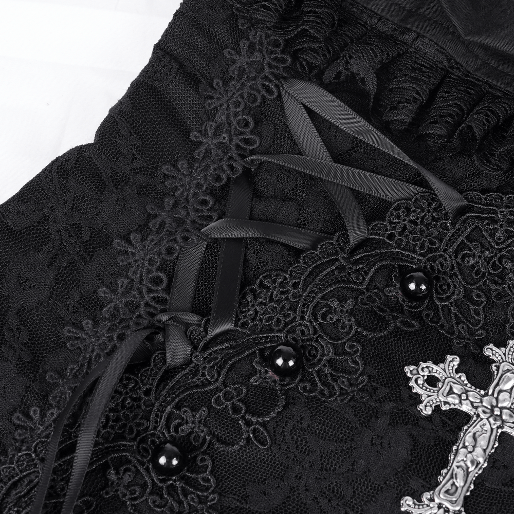 Close-up of black lace texture with ruching and cross detail on gothic halter mini dress.
