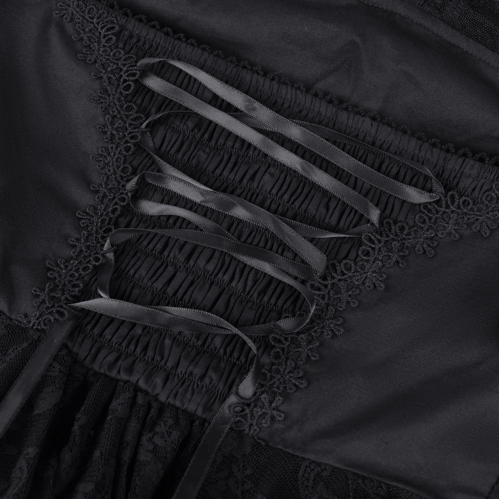 Close-up of black lace mini dress showing ruched details and satin ribbons for a gothic and feminine style.