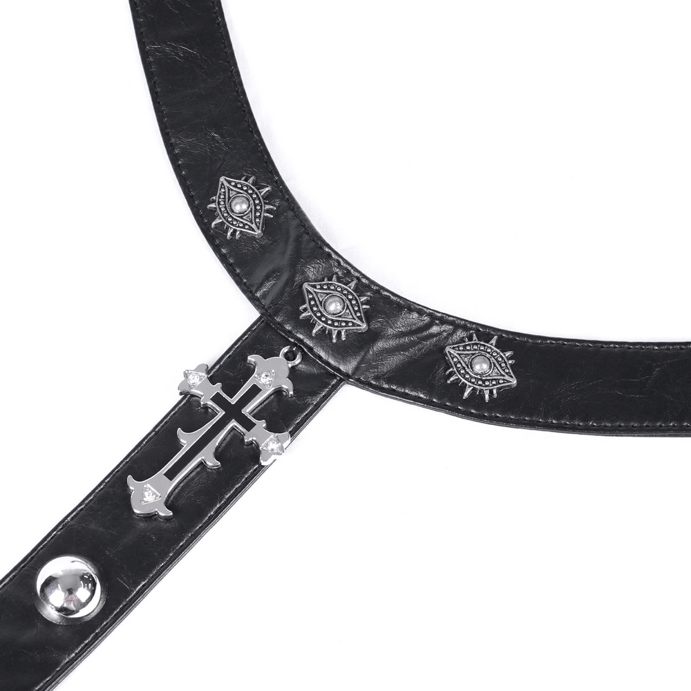 Close-up of a gothic black leather choker with silver cross and eye motifs for edgy fashion.