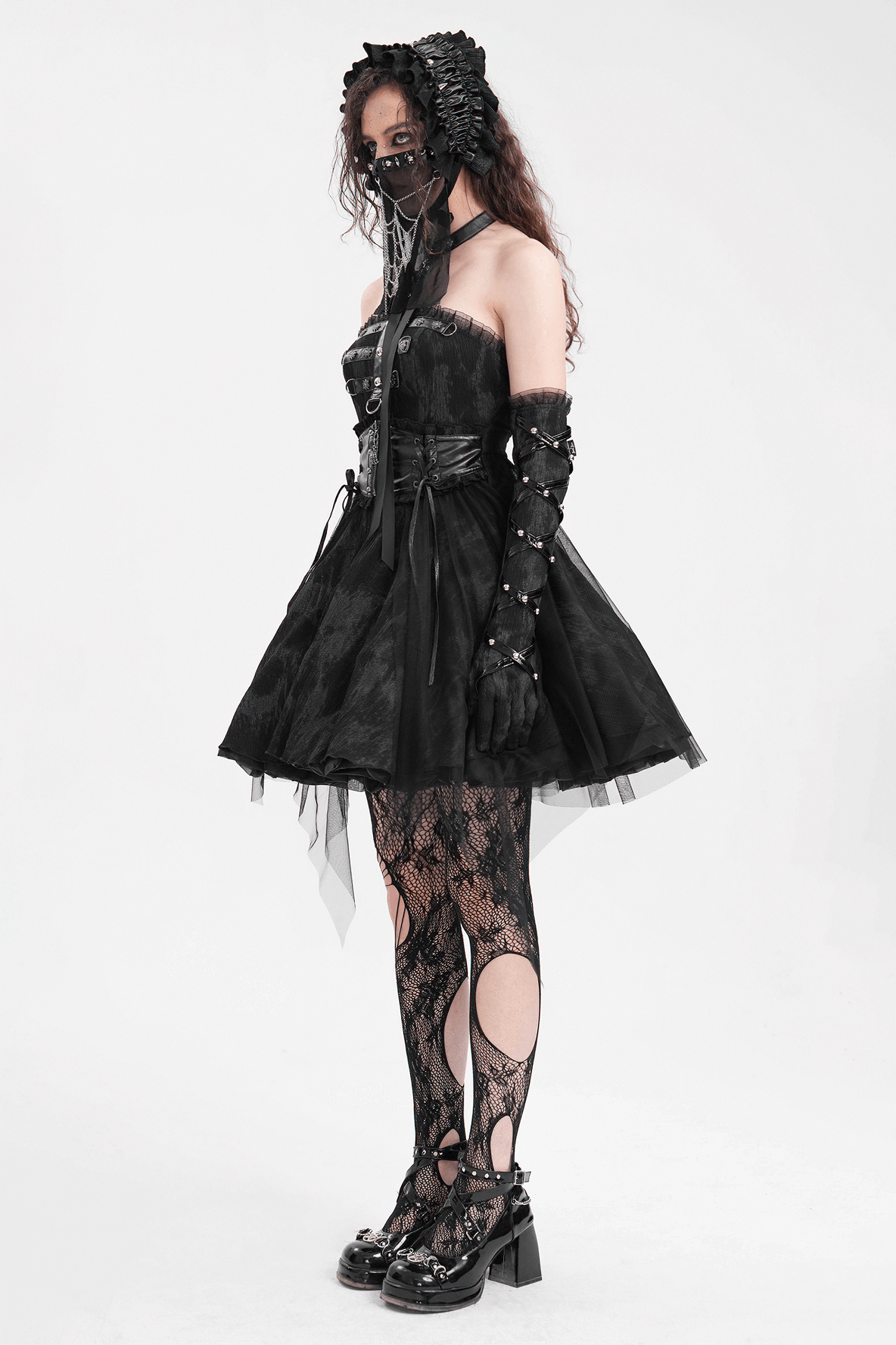 Gothic halter mini dress with lace-up back, tulle skirt, and edgy accessories for alternative fashion enthusiasts.