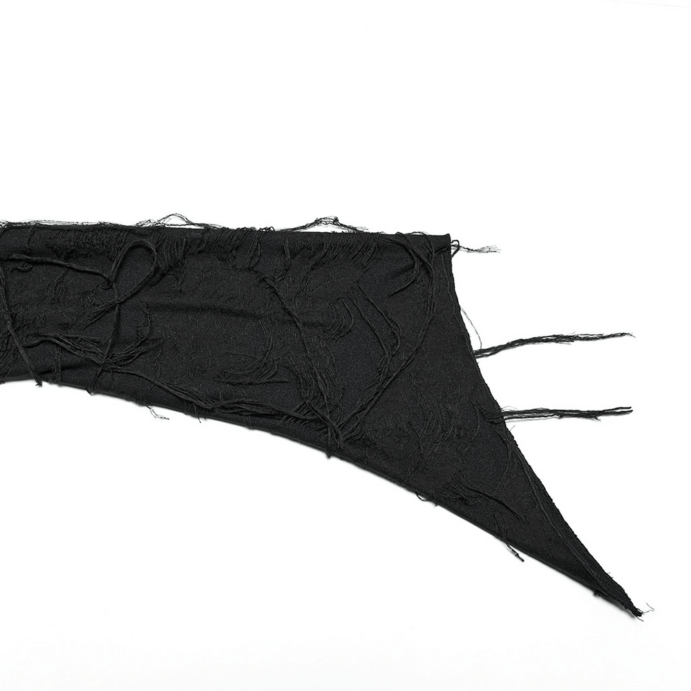 Close-up of Gothic black fabric with tattered edges, showcasing dramatic texture for fashion enthusiasts.