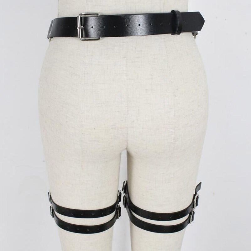 Gothic handmade leather garter belts for women, stylish waist harness with metal elements on a mannequin.