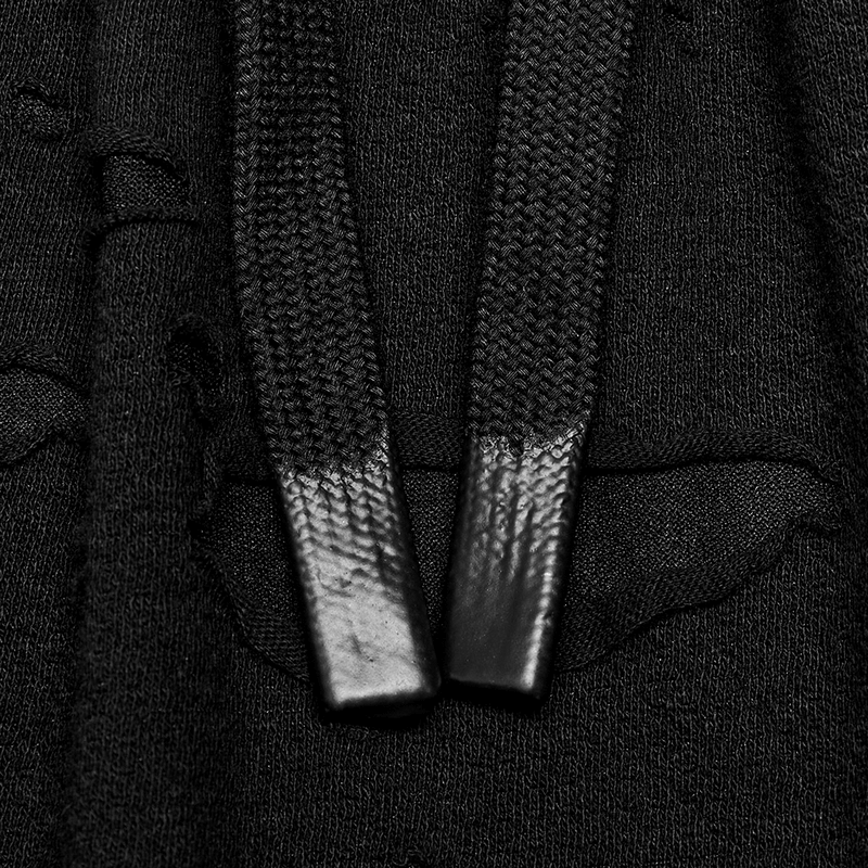 Close-up of black pants showing detachable loops and distressed fabric, perfect for Gothic style enthusiasts.