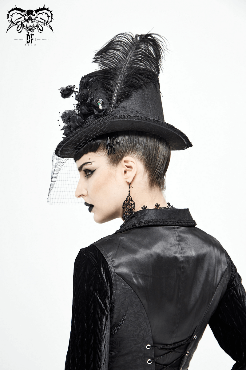 Gothic black hat with detachable feather and flowers, worn elegantly by a model in vintage attire.
