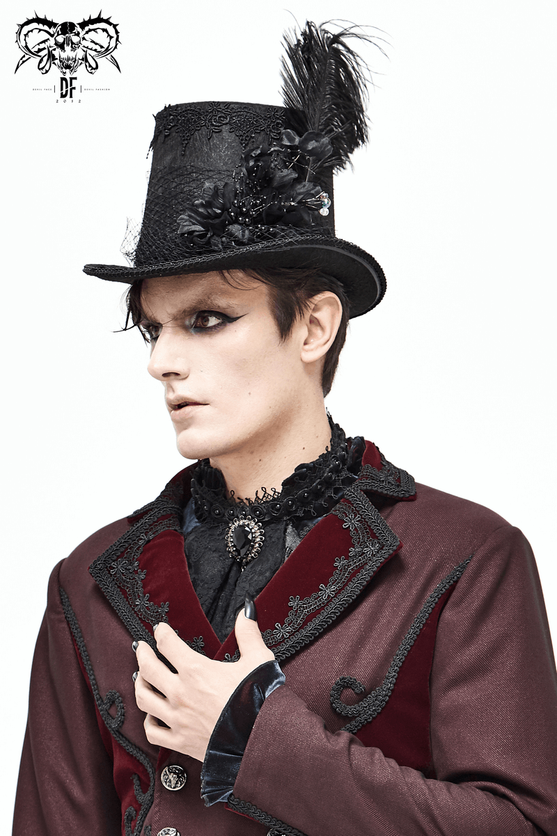 Elegant gothic black top hat with feathers and flowers, worn by a model in vintage attire.