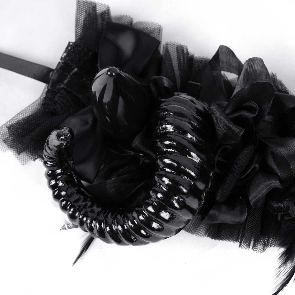 Dark gothic headpiece with curled black horns and black floral accents, perfect for edgy fashion looks.