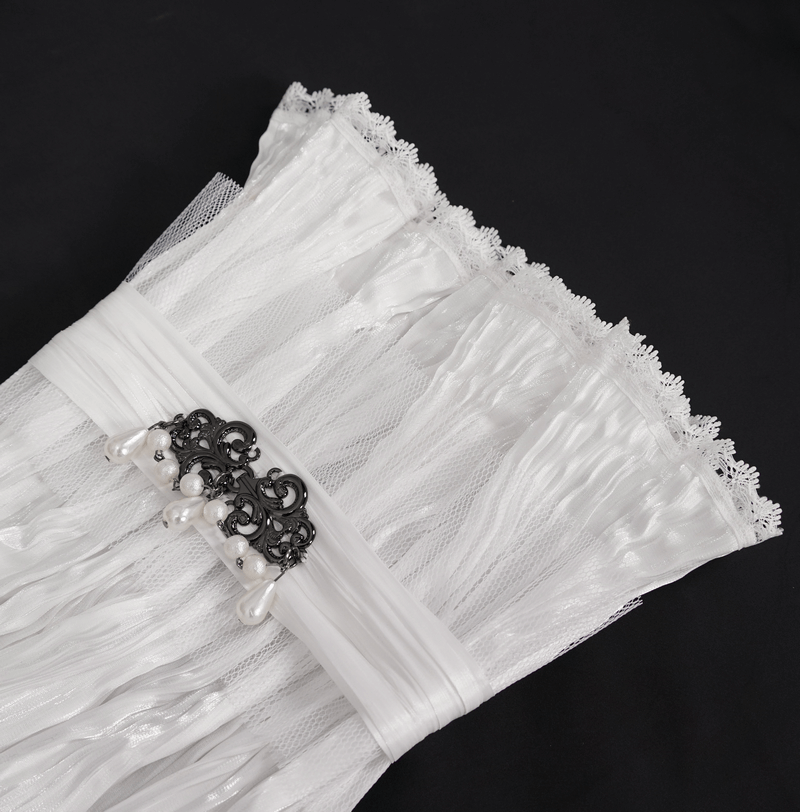 Gothic white lace high collar with beaded brooch and ruffle hem on black background.