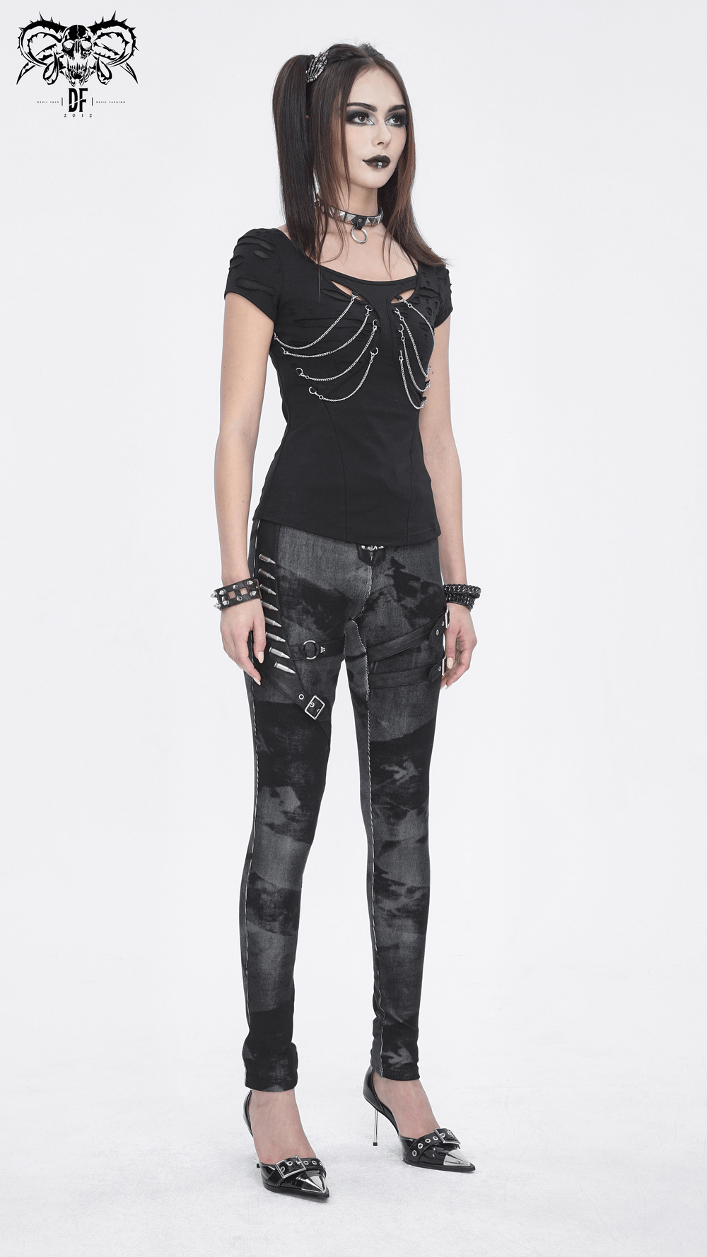 Punk model in Gothic high-waist lace-up pants with buckles, showcasing edgy fashion and unique design elements.