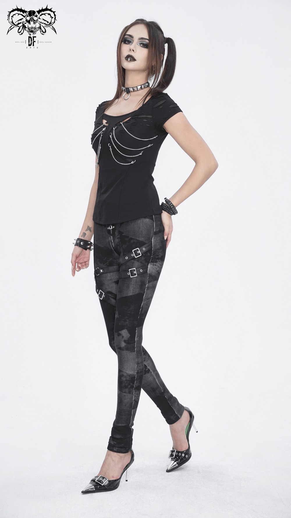 Gothic high-waist lace-up skinny pants with buckles, paired with edgy accessories and unique top.