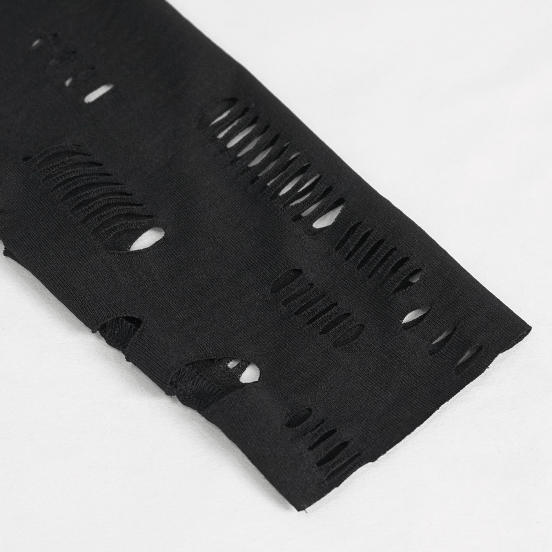 Close-up of black fabric with edgy cut-out holes, showcasing gothic style and modern fashion trends.
