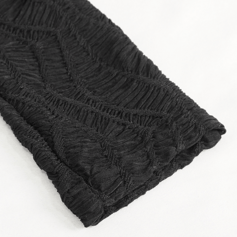 Close-up of black lace fabric with textured pattern, showcasing gothic-style leggings design.