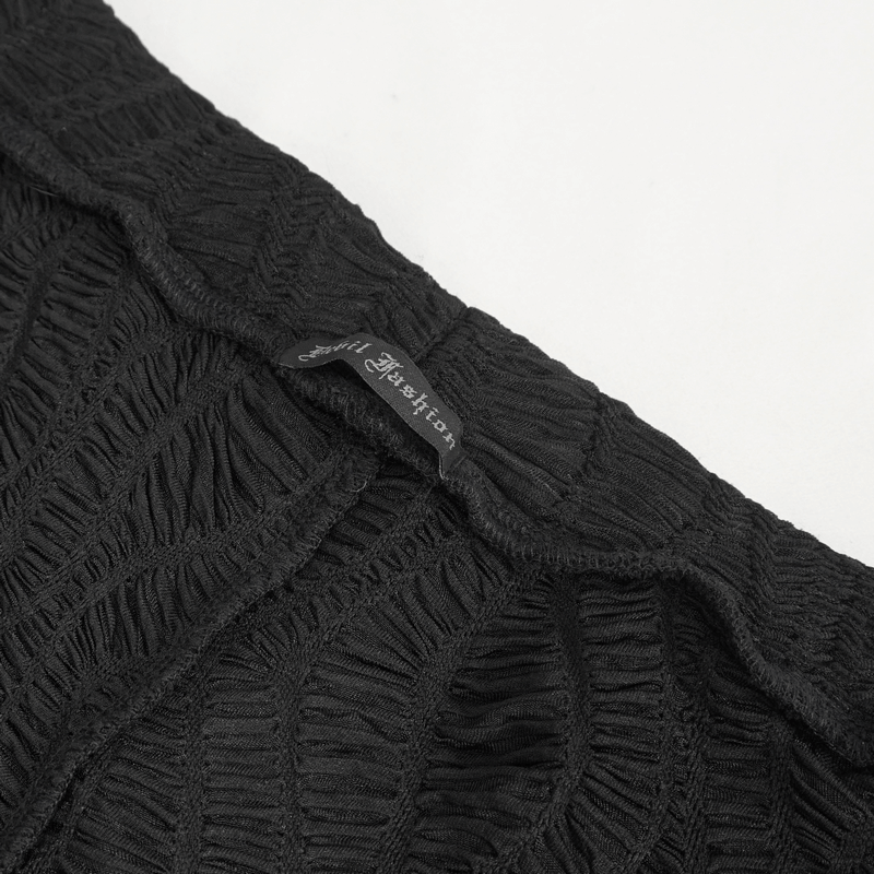 Close-up of black lace leggings featuring intricate texture and brand tag for gothic style fashion.