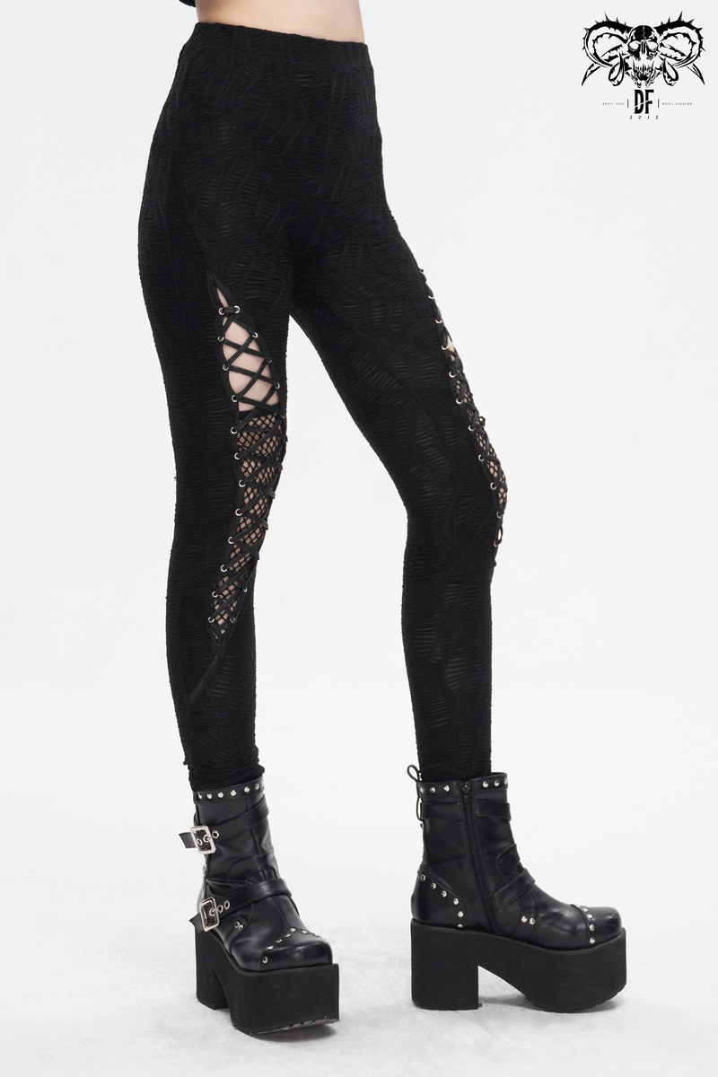 Gothic lace-up leggings with mesh patchwork, paired with edgy platform boots, embodying dark elegance.