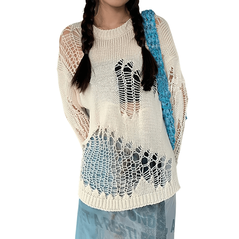 Model wearing a gothic hollow out oversized knitted sweater with long sleeves and see-through design.