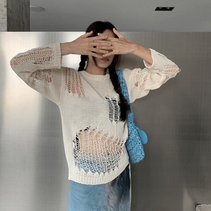 Gothic oversized hollow-out knitted sweater with long sleeves, styled with a blue bag, showcasing a grunge look.