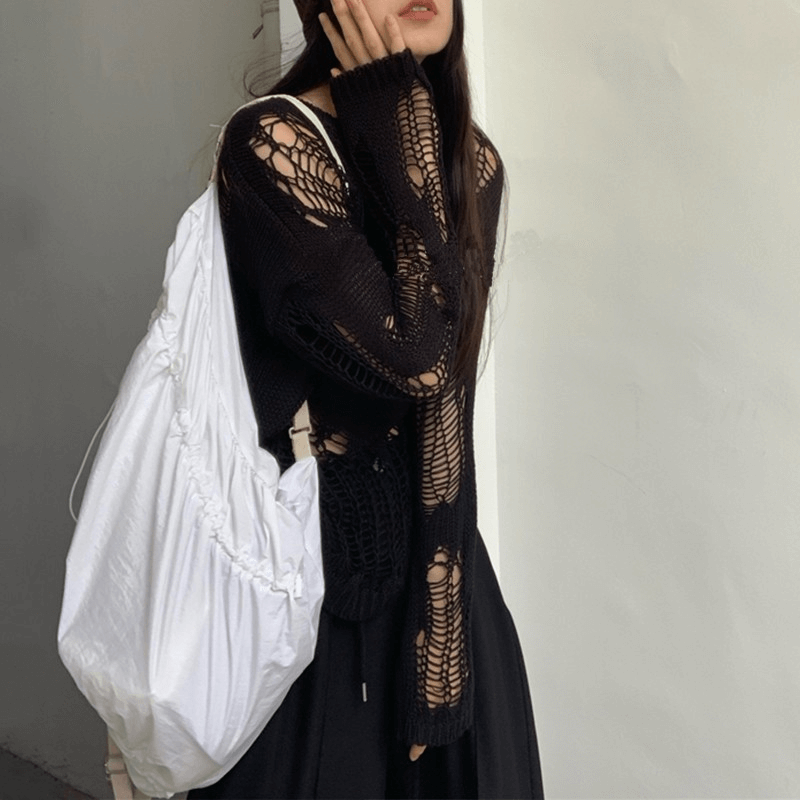 Gothic hollow-out oversized knitted sweater with long sleeves and a stylish white bag, perfect for grunge fashion.