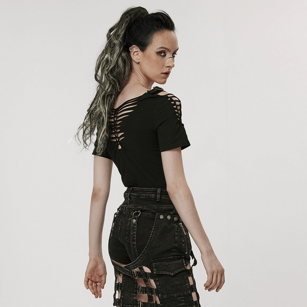 Back view of a woman in a Gothic hollow-out woven t-shirt, showcasing bold cutouts and punk streetwear style.