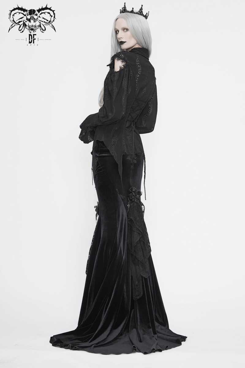Gothic style model in a black lantern sleeves blouse with a vintage cut and a sleek velvet skirt.