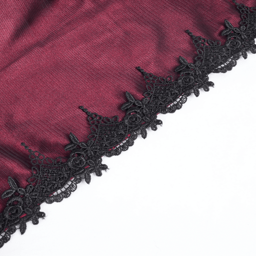 Close-up of intricate black lace detailing on a gothic satin hooded cape, highlighting elegance and texture.