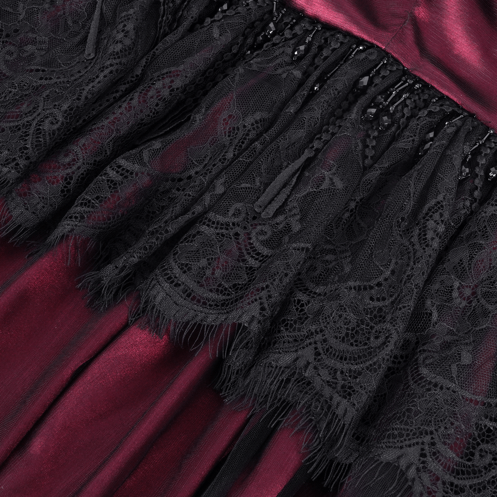 Close-up of lace and satin detailing on a Gothic hooded cape, showcasing intricate patterns and rich textures.