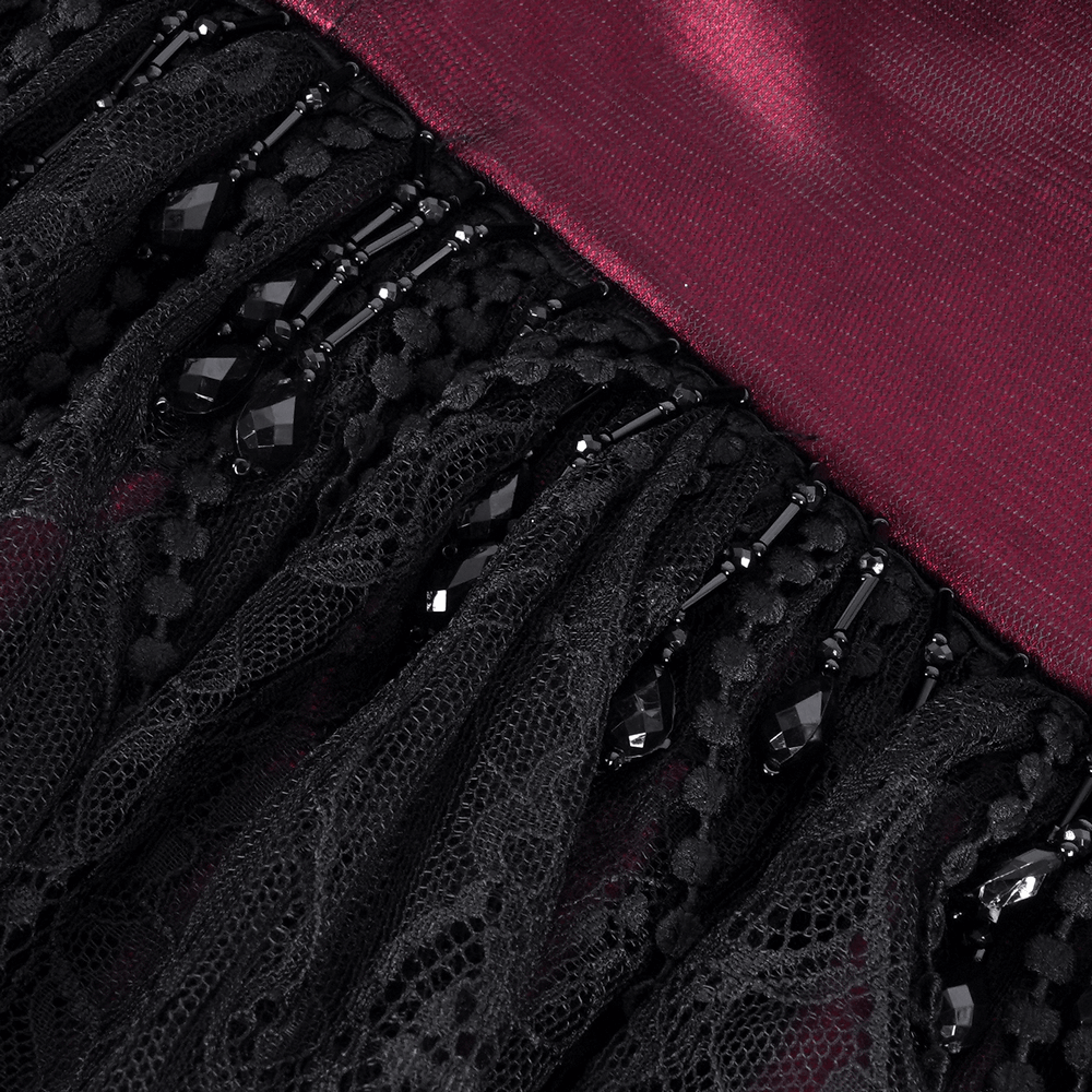 Close-up of elegant satin fabric with intricate black lace and bead detailing, perfect for gothic attire.