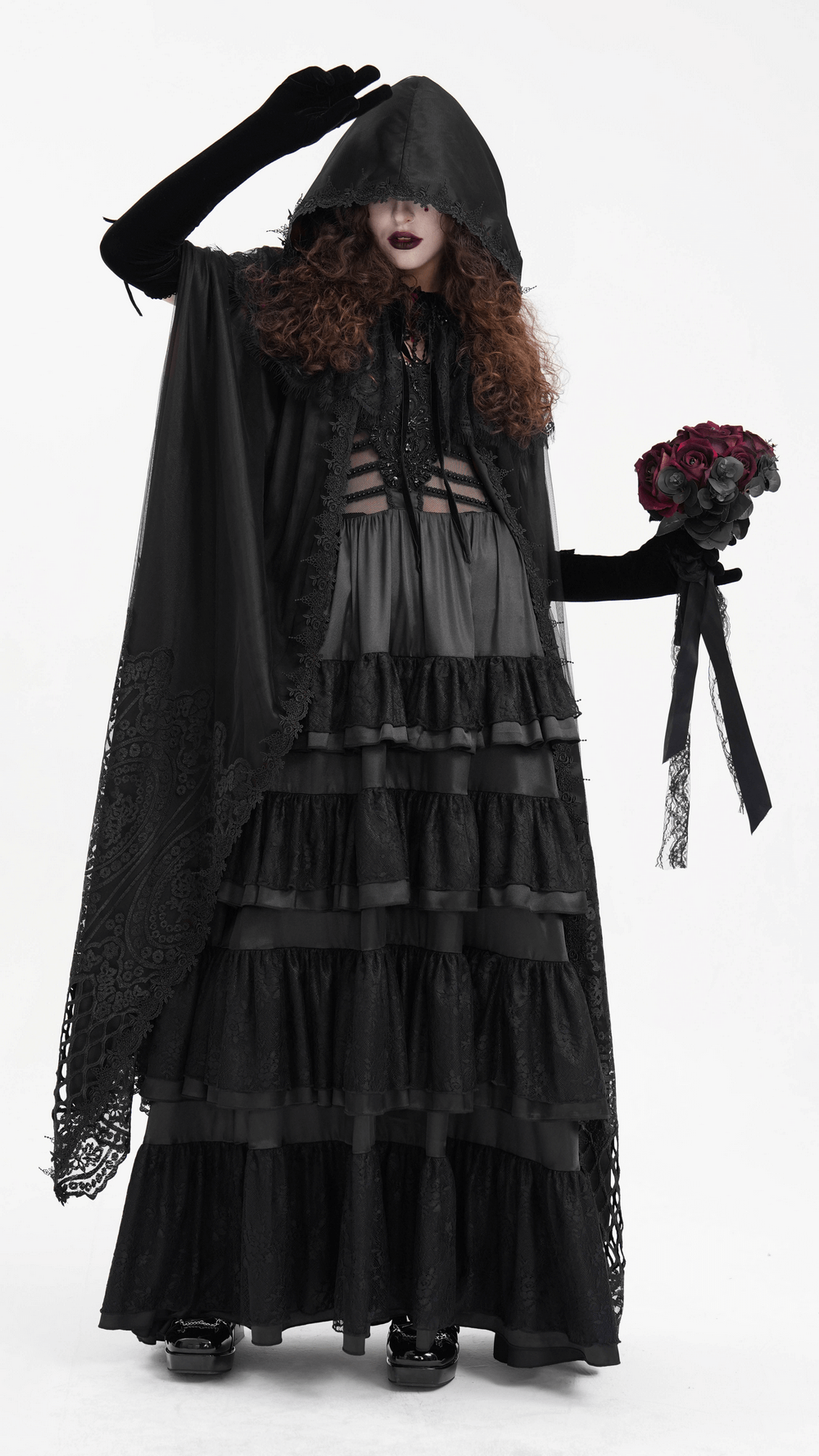 Gothic hooded cape with lace embroidery, worn by a model holding a bouquet, creating a darkly elegant look.