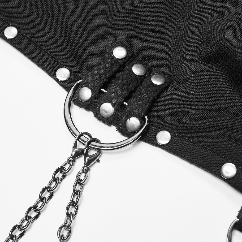 Close-up of gothic chain detail on black knitted top featuring riveted leather cuffs and D-buckles.