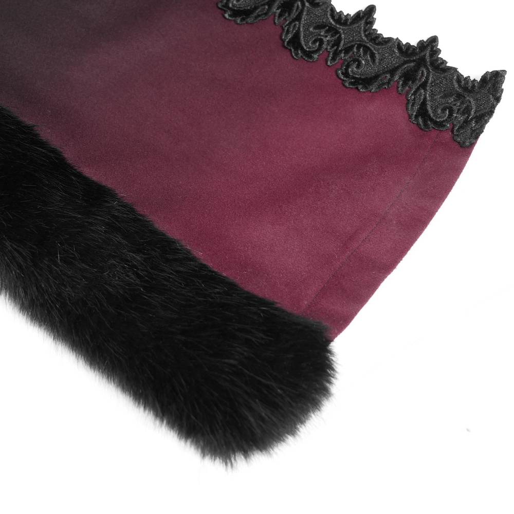 Close-up of gothic cloak's ombre red fabric and black fur trim, showcasing elegant embroidery detail.