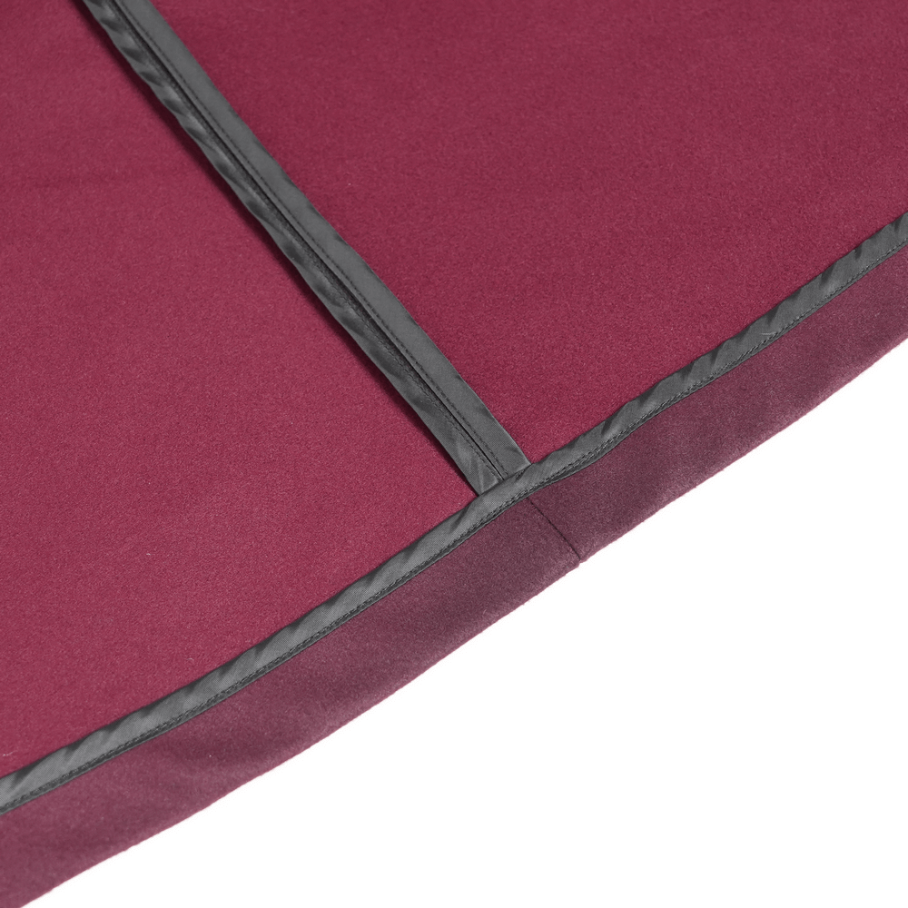 Close-up of the burgundy ombre hem and contrasting trim of a gothic hooded cloak.