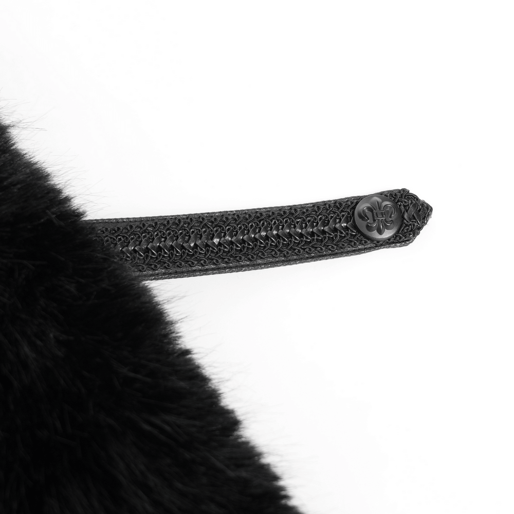 Close-up of the intricate button and secure closure strap on a gothic hooded cloak with black fur trim.
